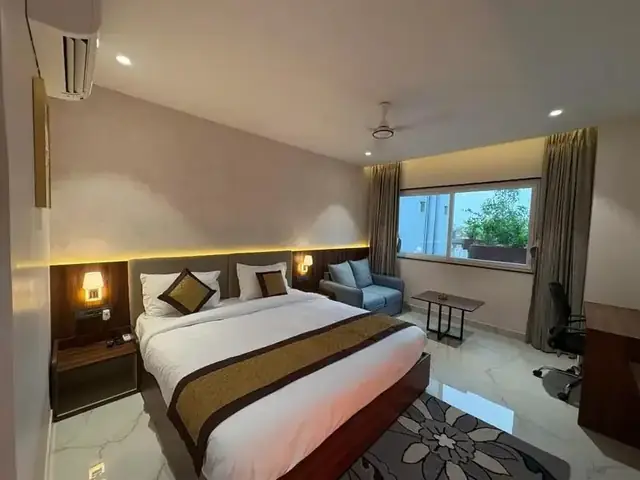 Deluxe Room at Basera Hotel with sofa and work desk