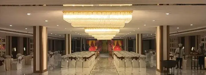 Jalsa banquet hall dressed for a wedding, floral stage and seating down the centre