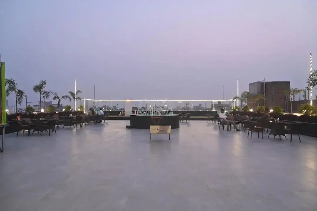 Rooftop terrace at dusk with fountain and seating